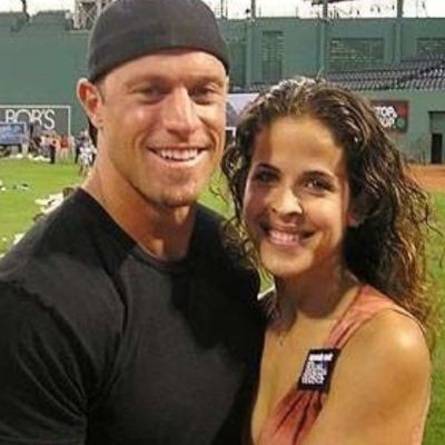 Gabe Kapler and Lisa Jansen are standing on the pitch as they are taking the picture.